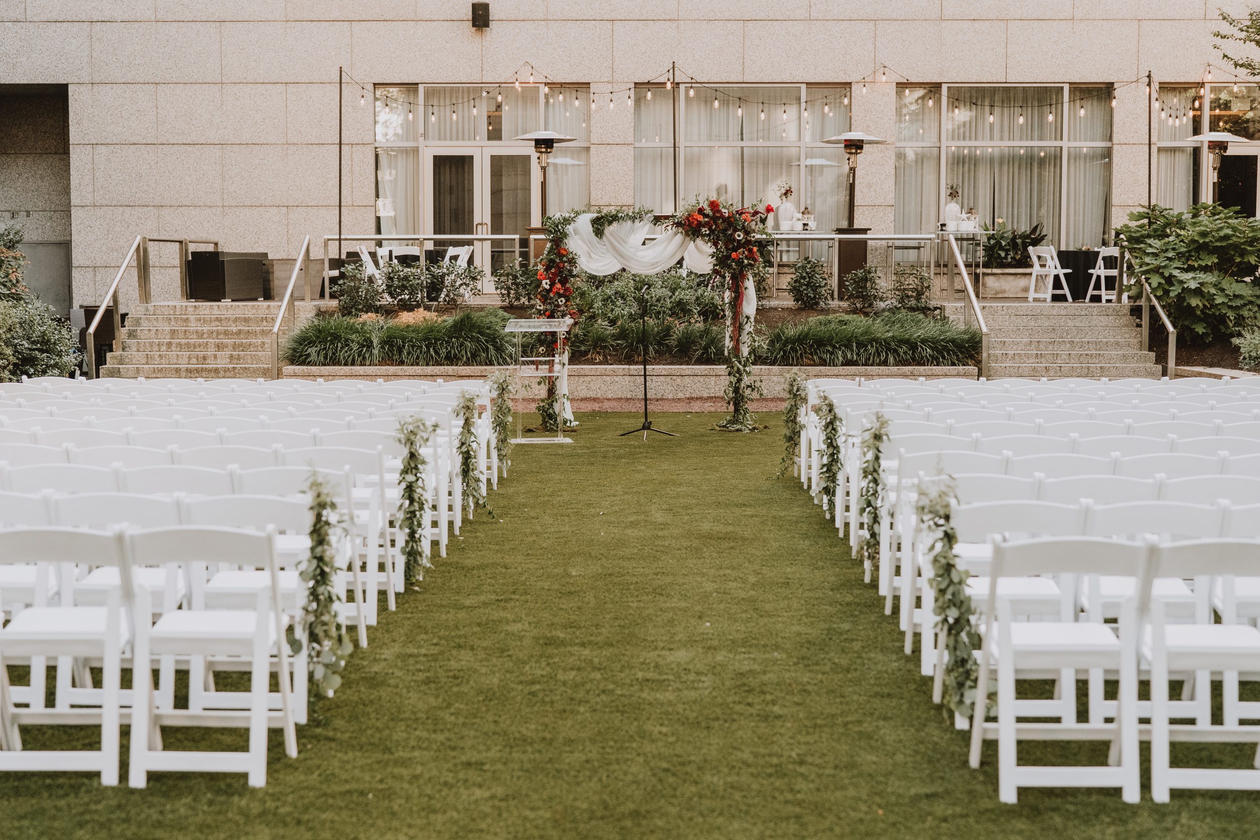 An outdoor wedding ceremony arranged on the lawn at the Logan Hotel