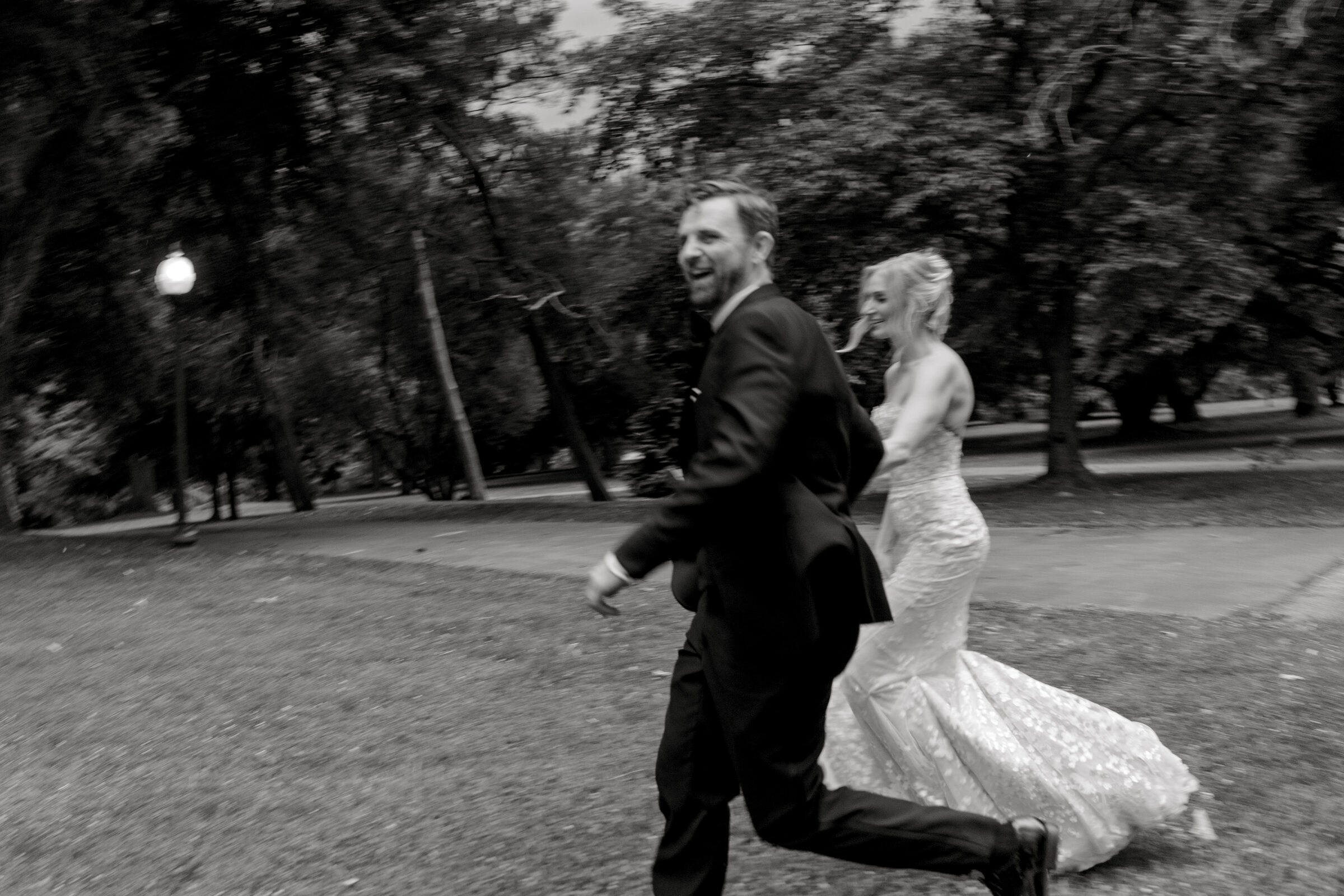 Gabby and Edwin run together through Fairmount Park on their Horticulture Center wedding day