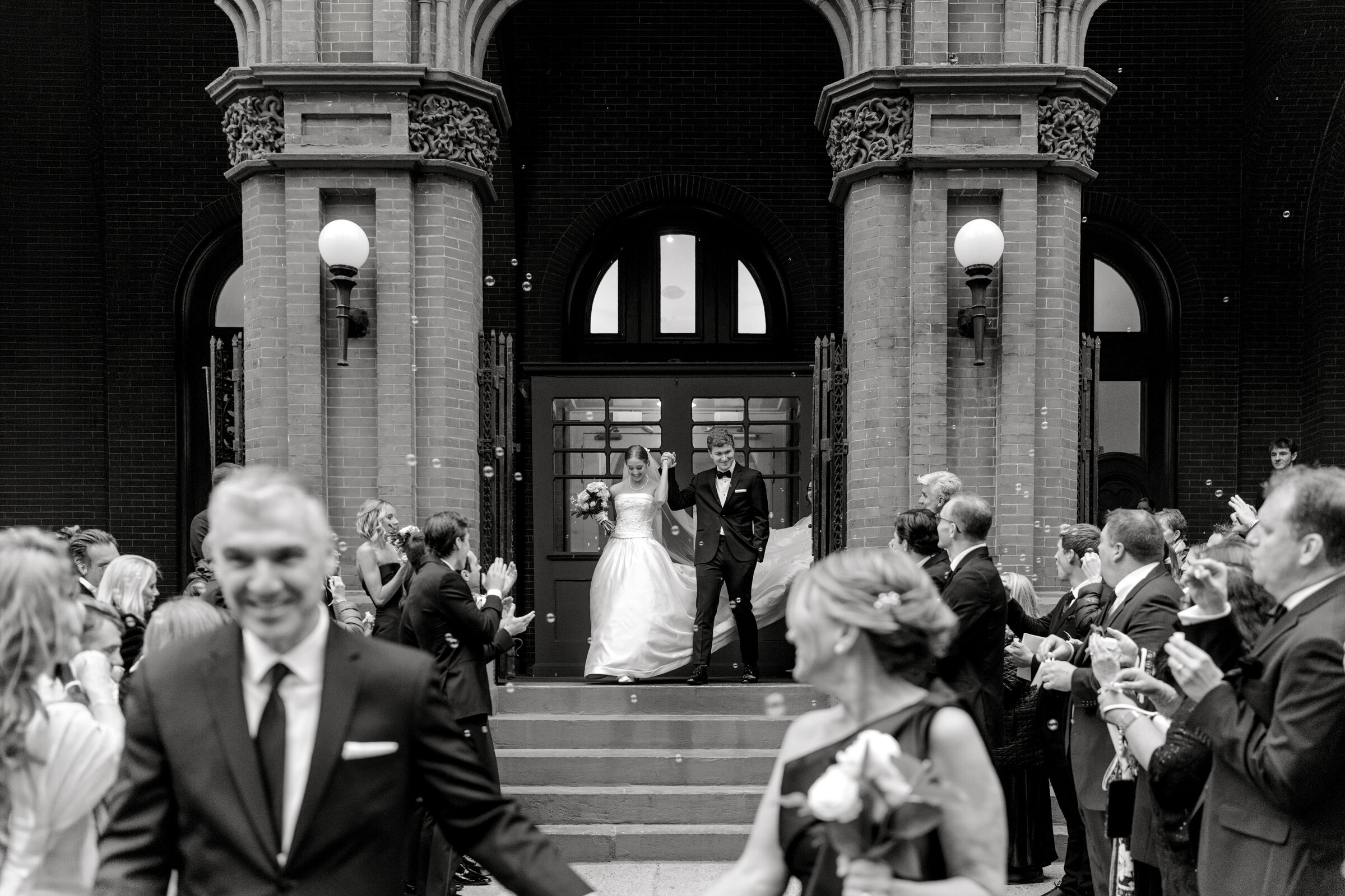Katie and AJ leave the Racquet Club of Philadelphia through cheering guests and bubbles
