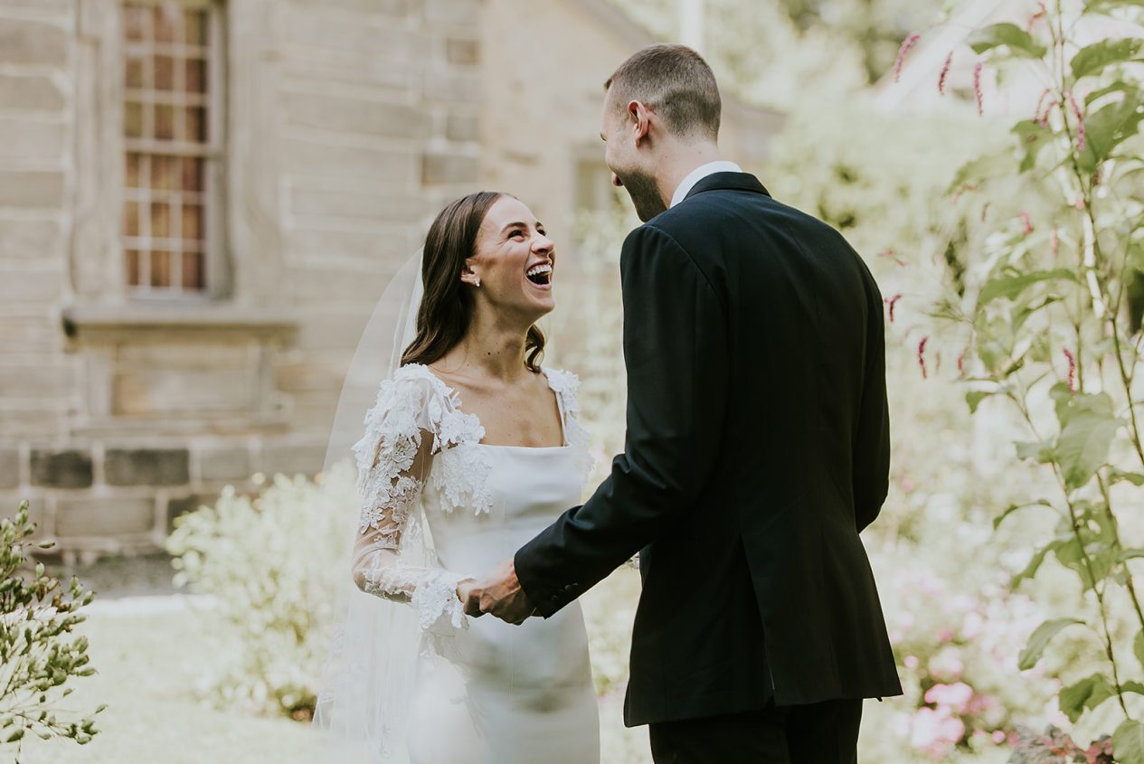 Vikki and Jake laughing together on their wedding day