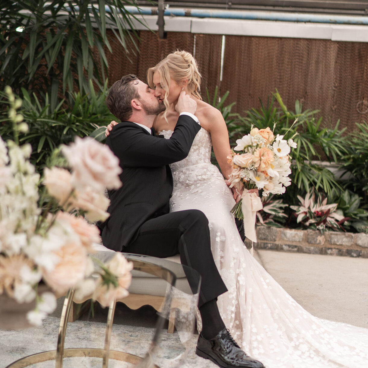 Gabbi and Edwin share a kiss among the greenery at the Horticulture Center in Philadelphia