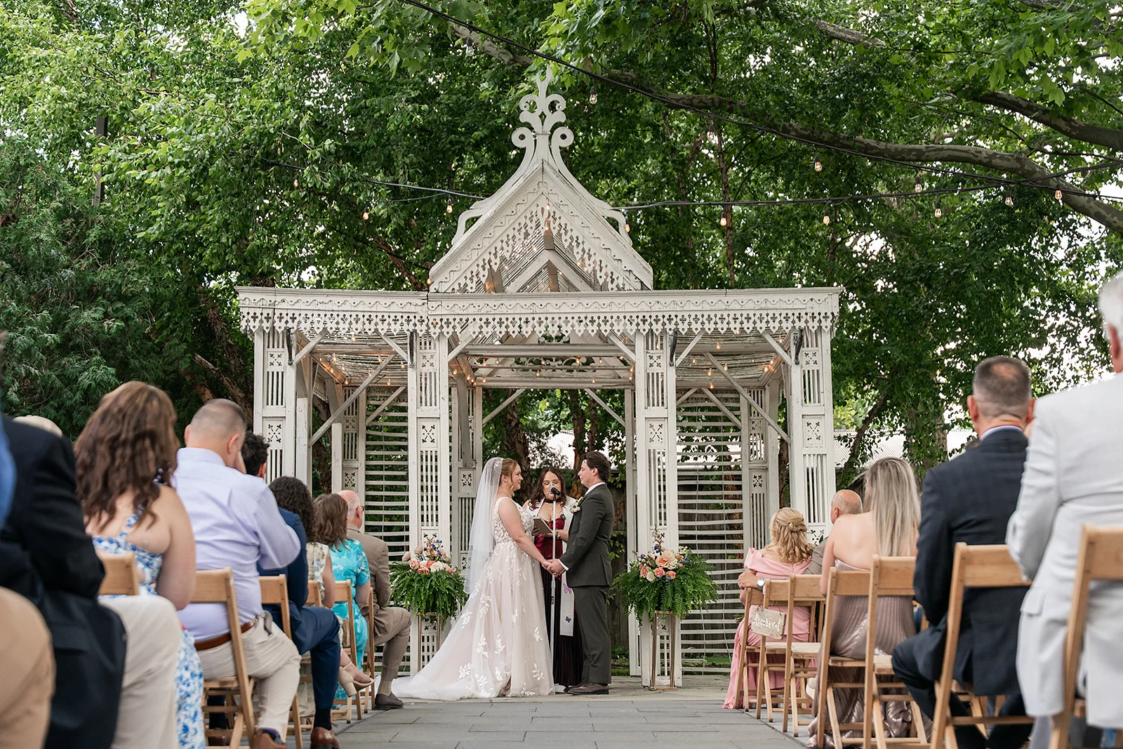A wedding ceremony beneath the white Wedding Temple at Terrain at Styer's