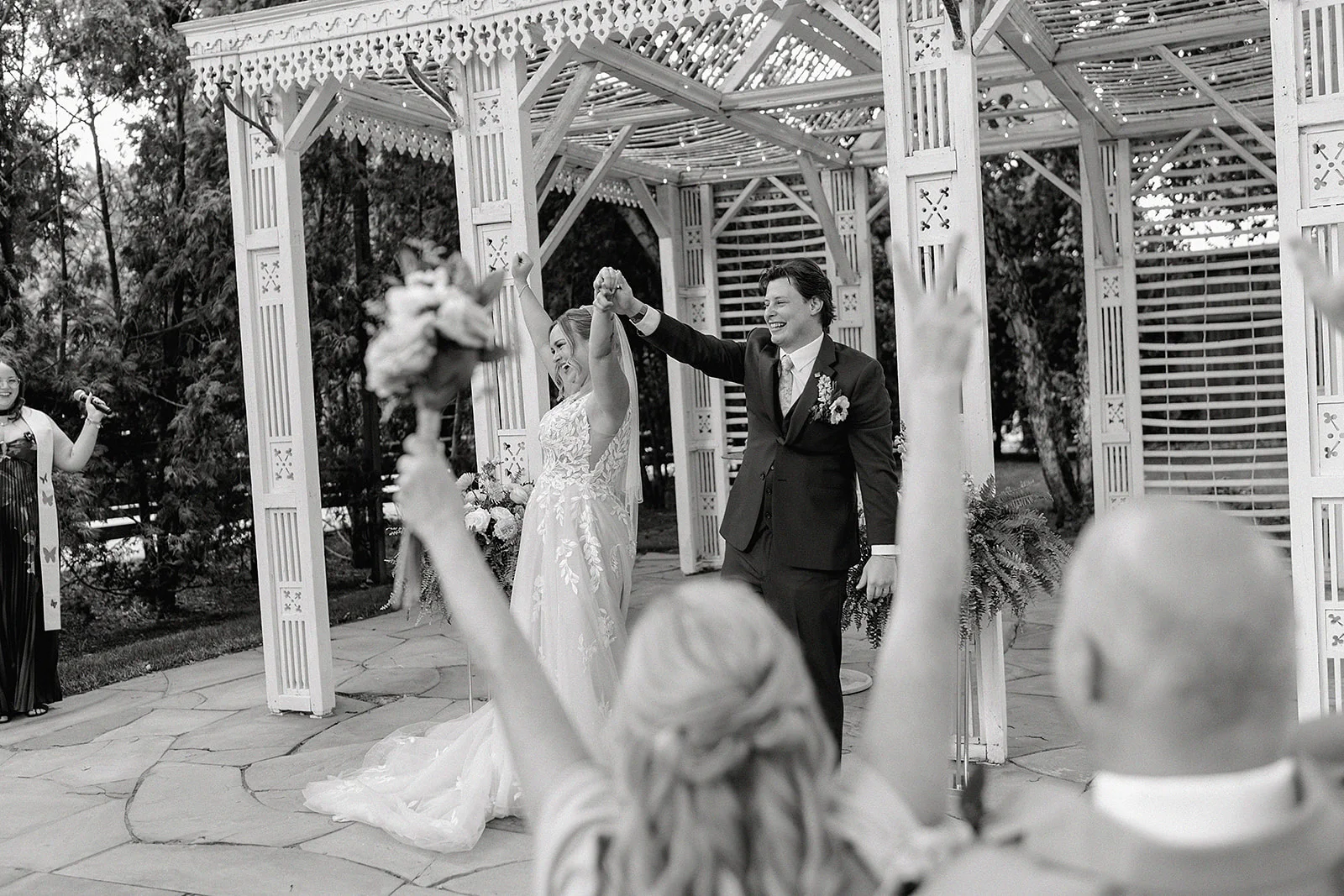 Newlyweds leaving their Terrain at Styer's ceremony as guests celebrate