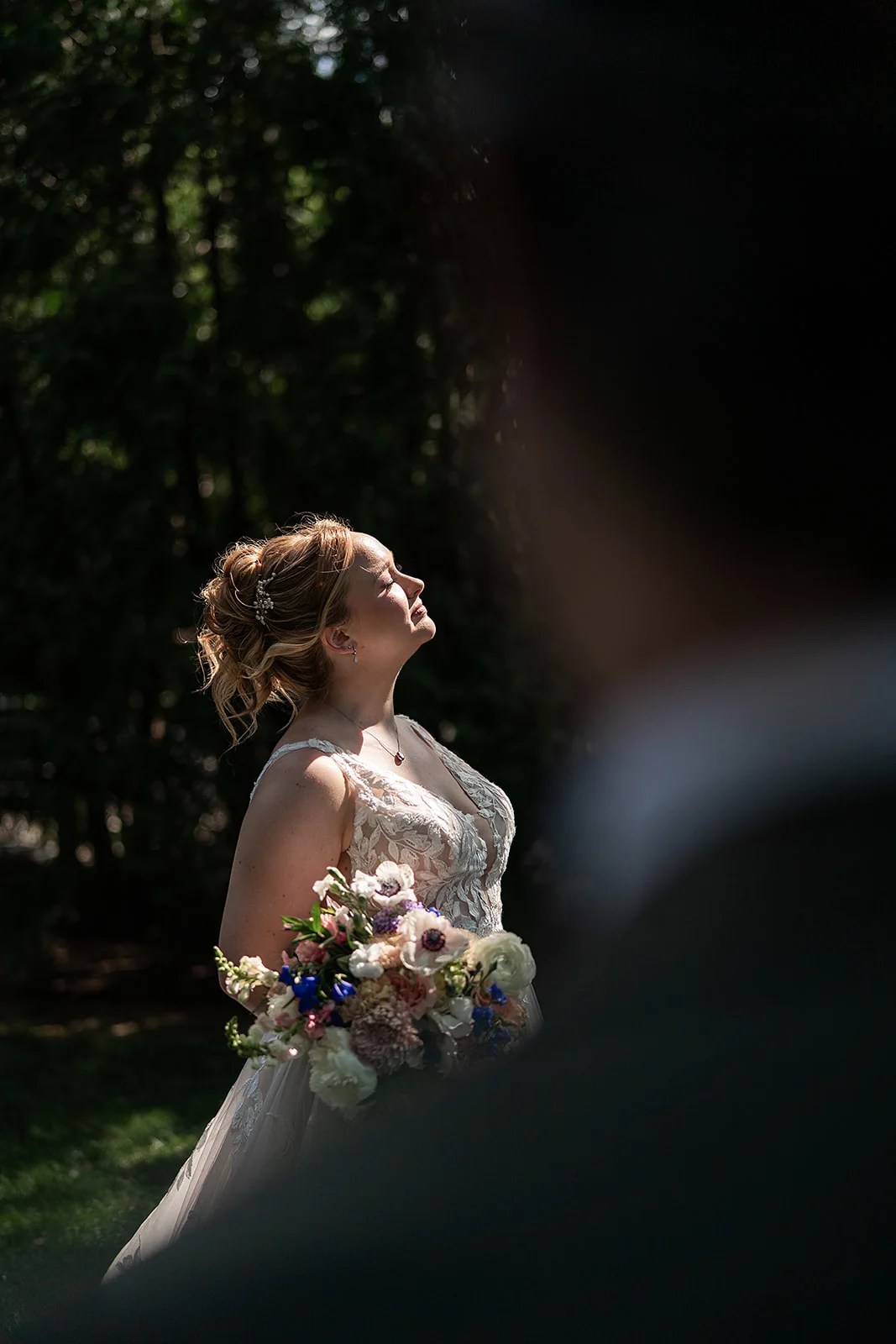 A bride illuminated by direct sunlight in the gardens at Terrain at Styer's