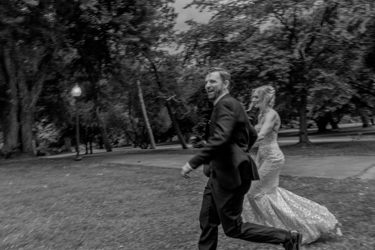 A couple moving through Fairmount Park on their Horticulture Center wedding day