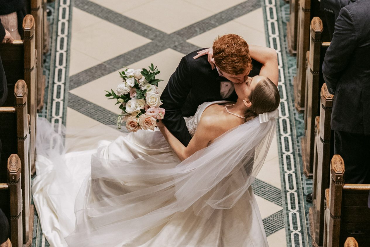 A newly married couple sharing a kiss at the Racquet Club of Philadelphia