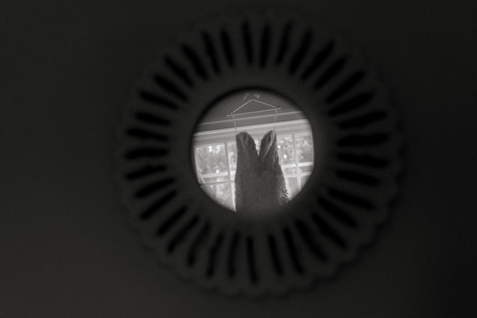 Audrey and Dan reflected in a dark circular mirror