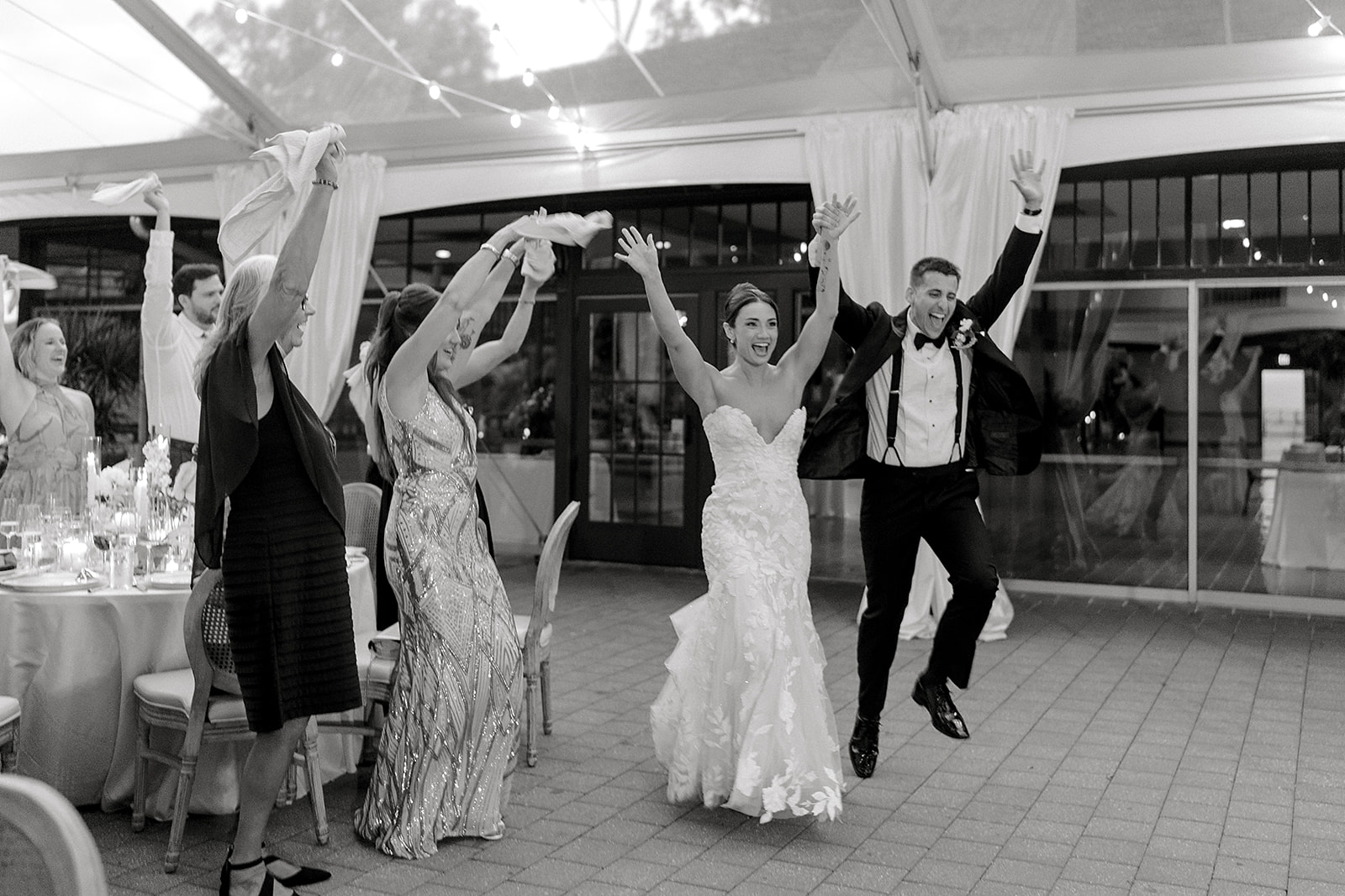 Audrey and Dan entering their Winterthur reception with guests cheering
