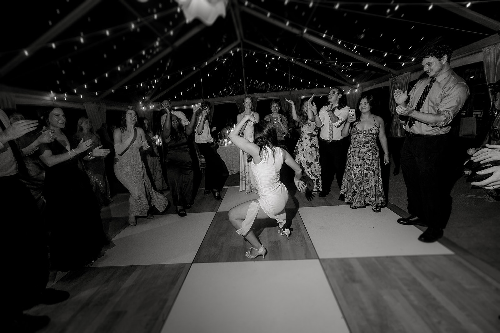 Audrey dancing while guests form a circle around her