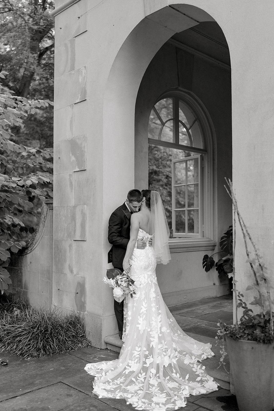 Dan kisses Audrey's shoulder as she rests in his arms at Winterthur