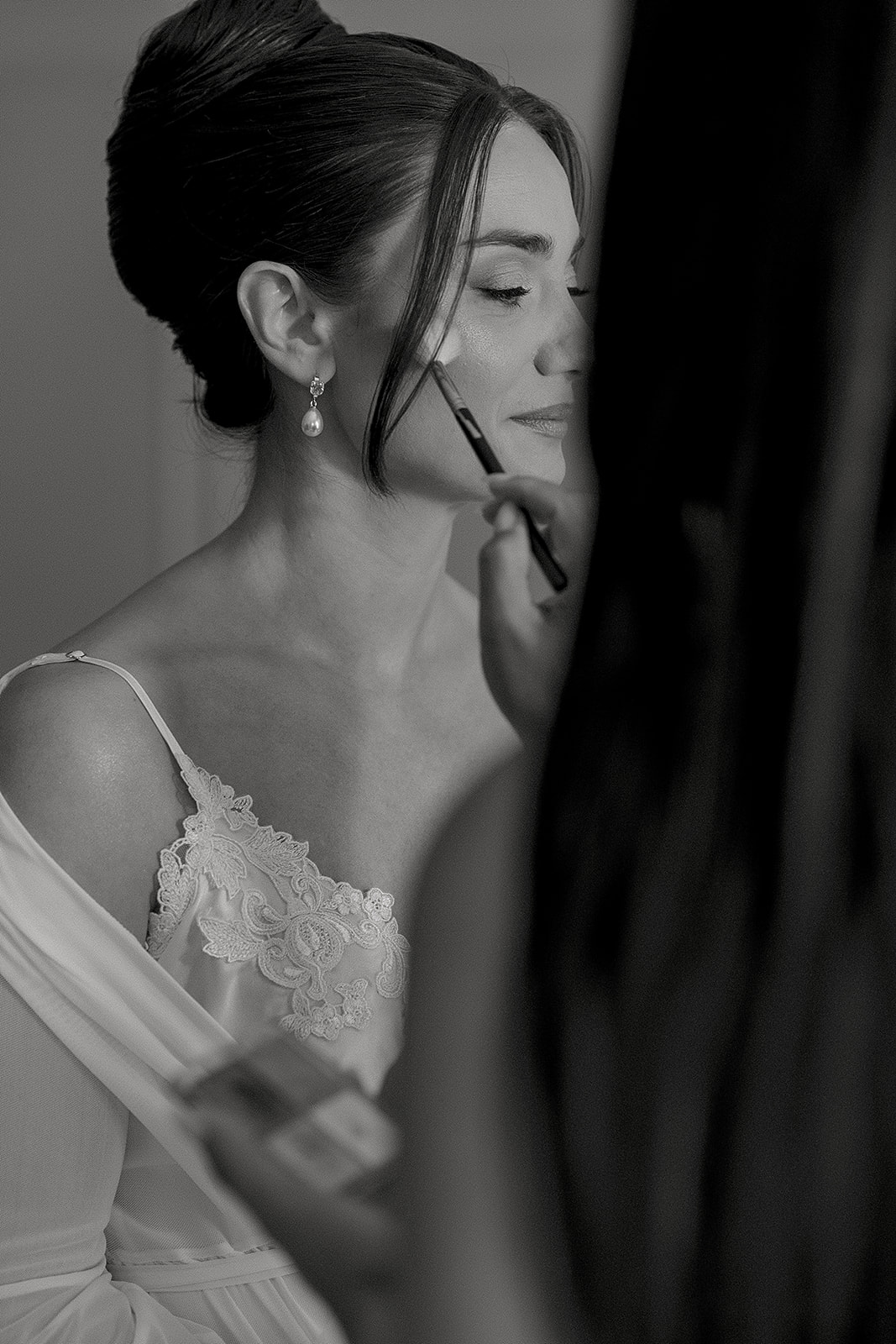 Audrey having her makeup applied before her Winterthur wedding